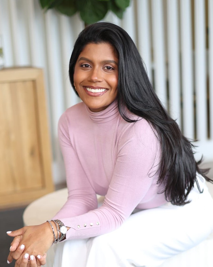 Karen Bentz seated, smiling, in a pink turtleneck